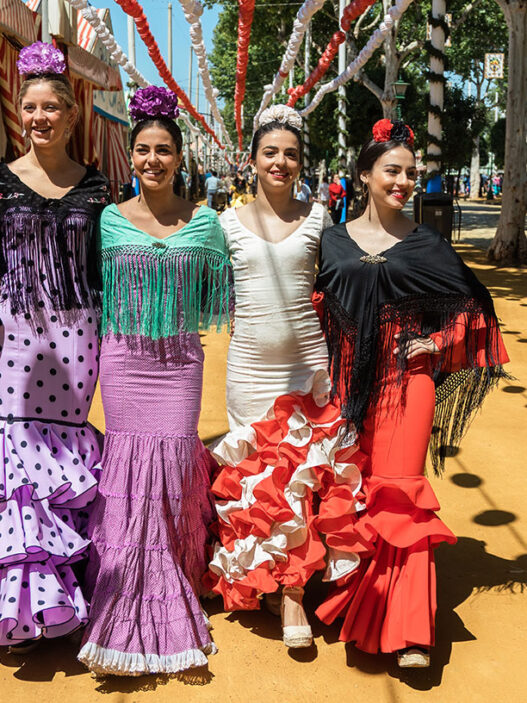 mujeres con vestidos flamencos en la Feria de Abril de Sevilla